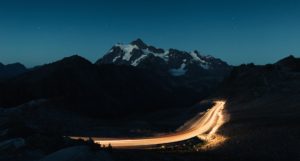 amazing night sky with snowy rocky mountains middle dimly lit road scaled e1604250397218